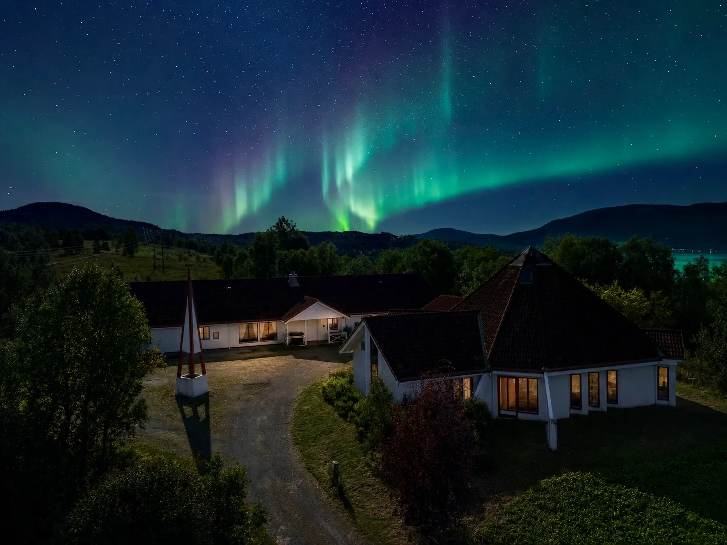Northern lights above Evenskjer Guesthouse and the surrounding landscape