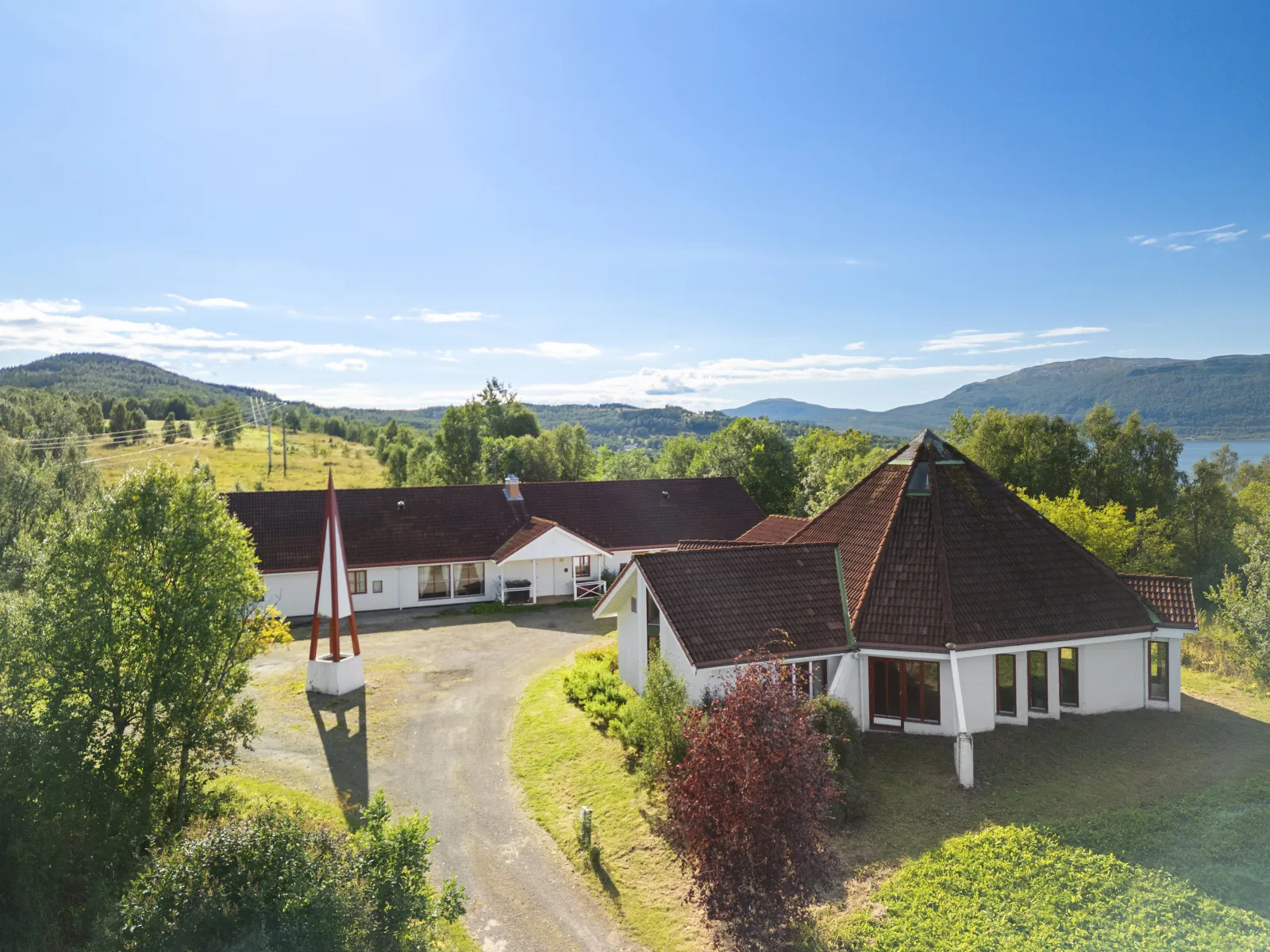 Evenskjer Guesthouse buildings with fjord and mountain views at Trøsen 47