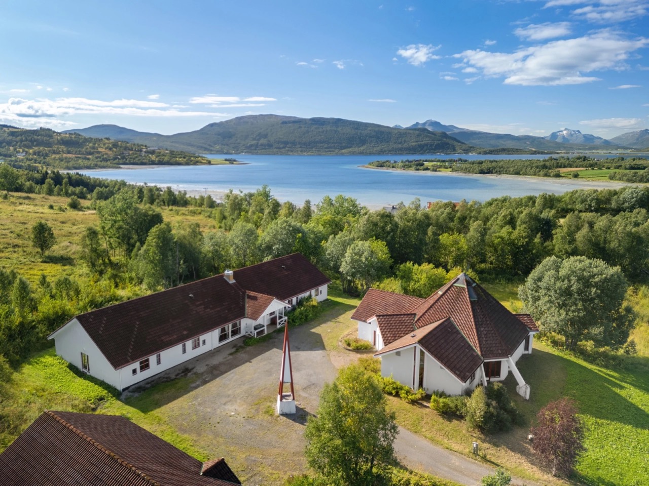 Trøsen 47 guesthouse property overlooking fjord and mountains